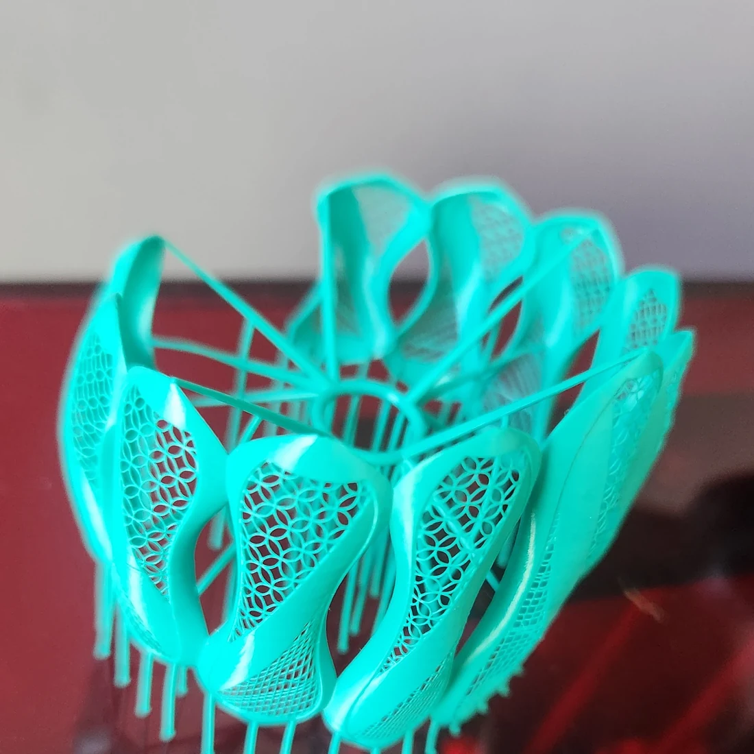 Prototipo turquesa con geometrías orgánicas y entramado fino